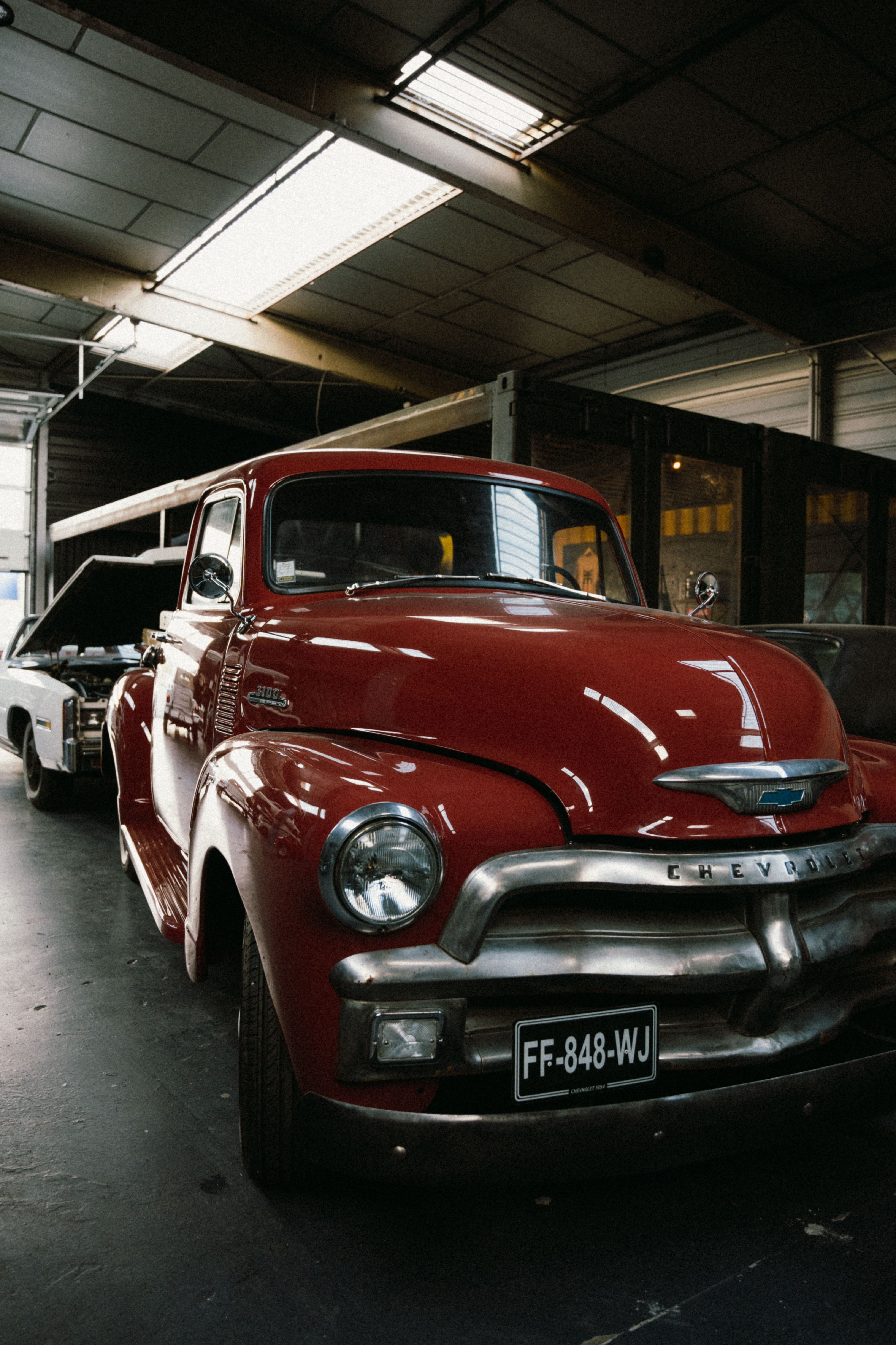 Vintage Chevrolet truck parked inside a garage in Montigny-le-Bretonneux, France.