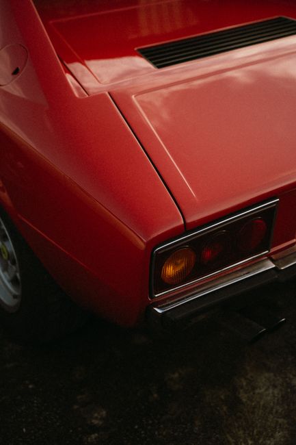 Close-up of a vintage red car's rear with classic design in Montigny-le-Bretonneux, France.
