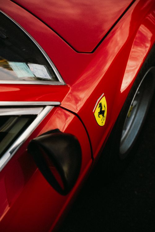 Free Detailed shot of a red Ferrari with the iconic emblem in Montigny-le-Bretonneux. Stock Photo