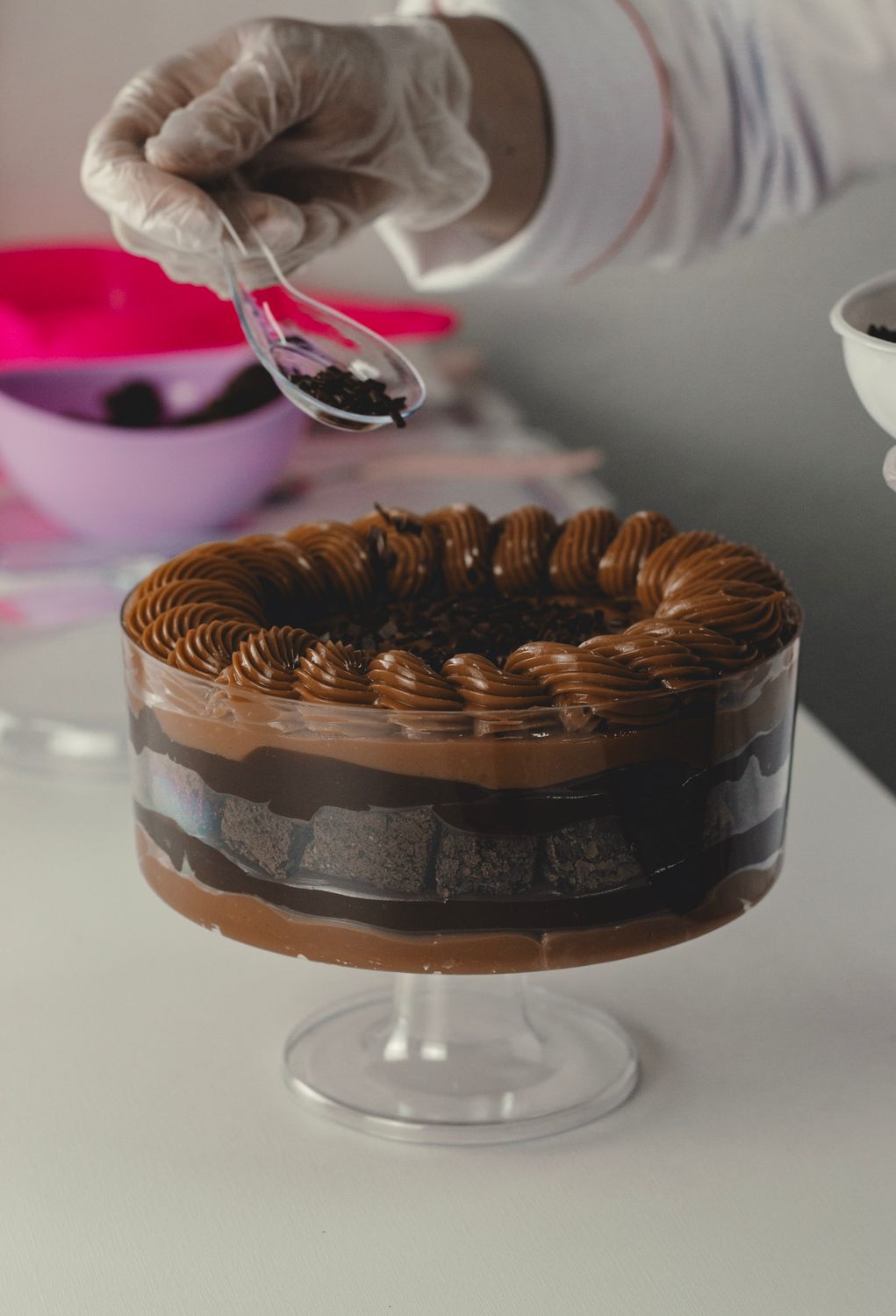 Chocolate Topping Using Decorator Adding Topping to Chocolate Layer Cake · Free Stock Photo