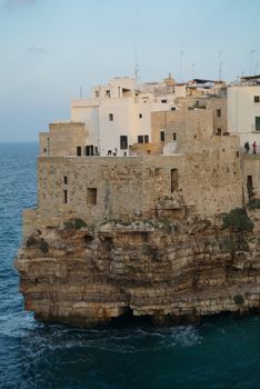 Charming coastal village perched on a cliff in Italy, showcasing stunning sea views.