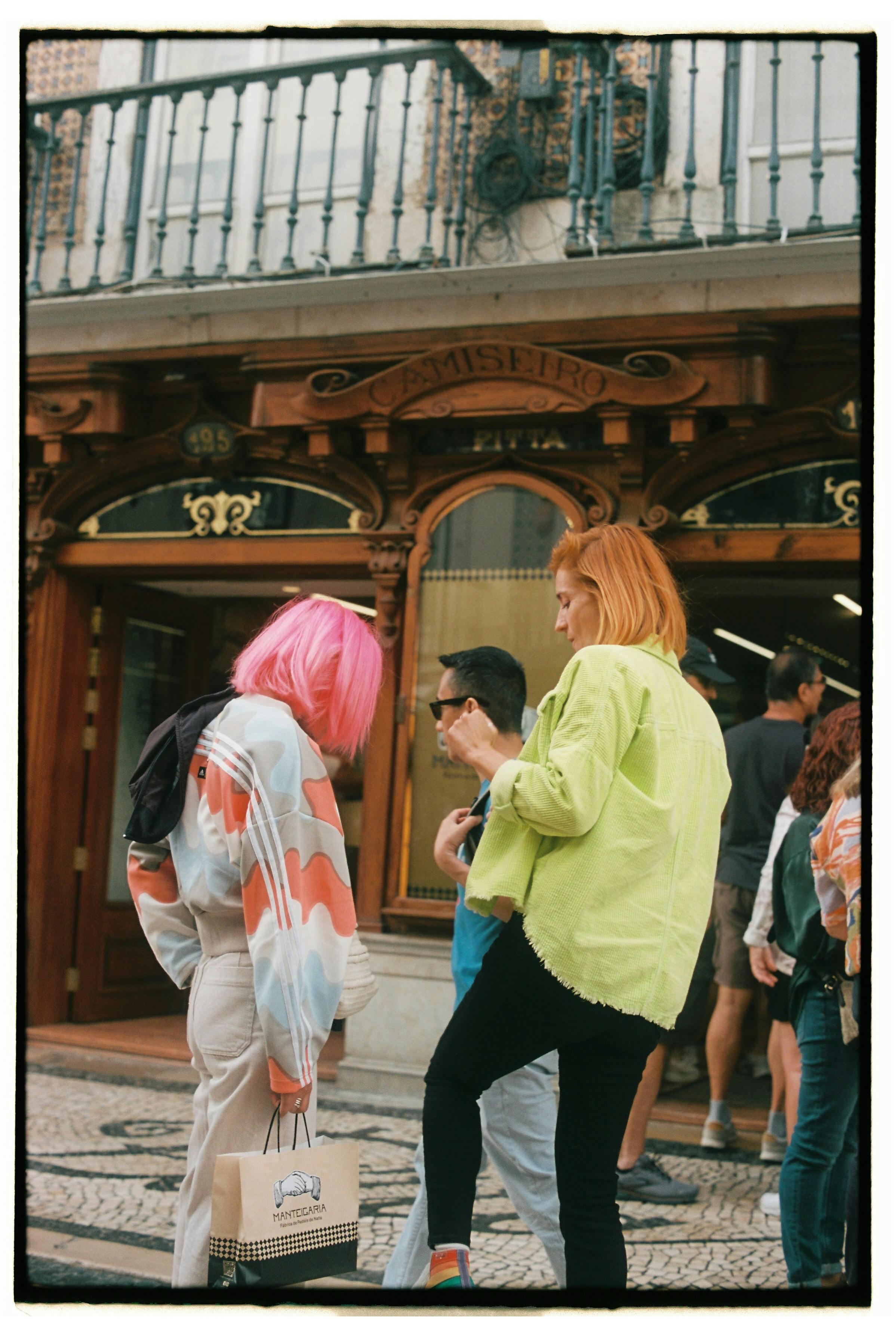 Vibrant fashion and street life captured in Lisbon's bustling historic district.