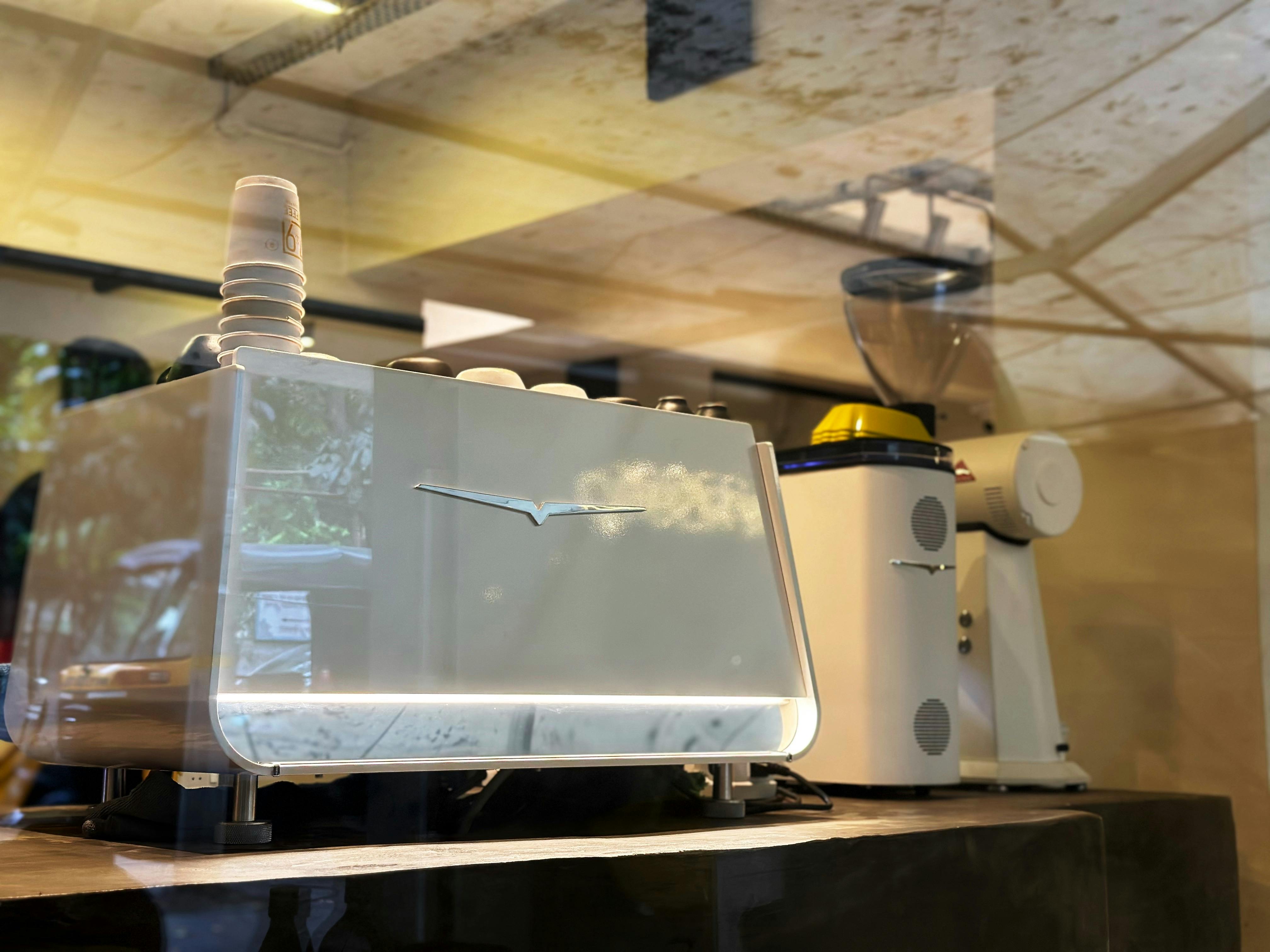 Modern espresso machine setup in a stylish cafe interior, showcasing coffee culture.