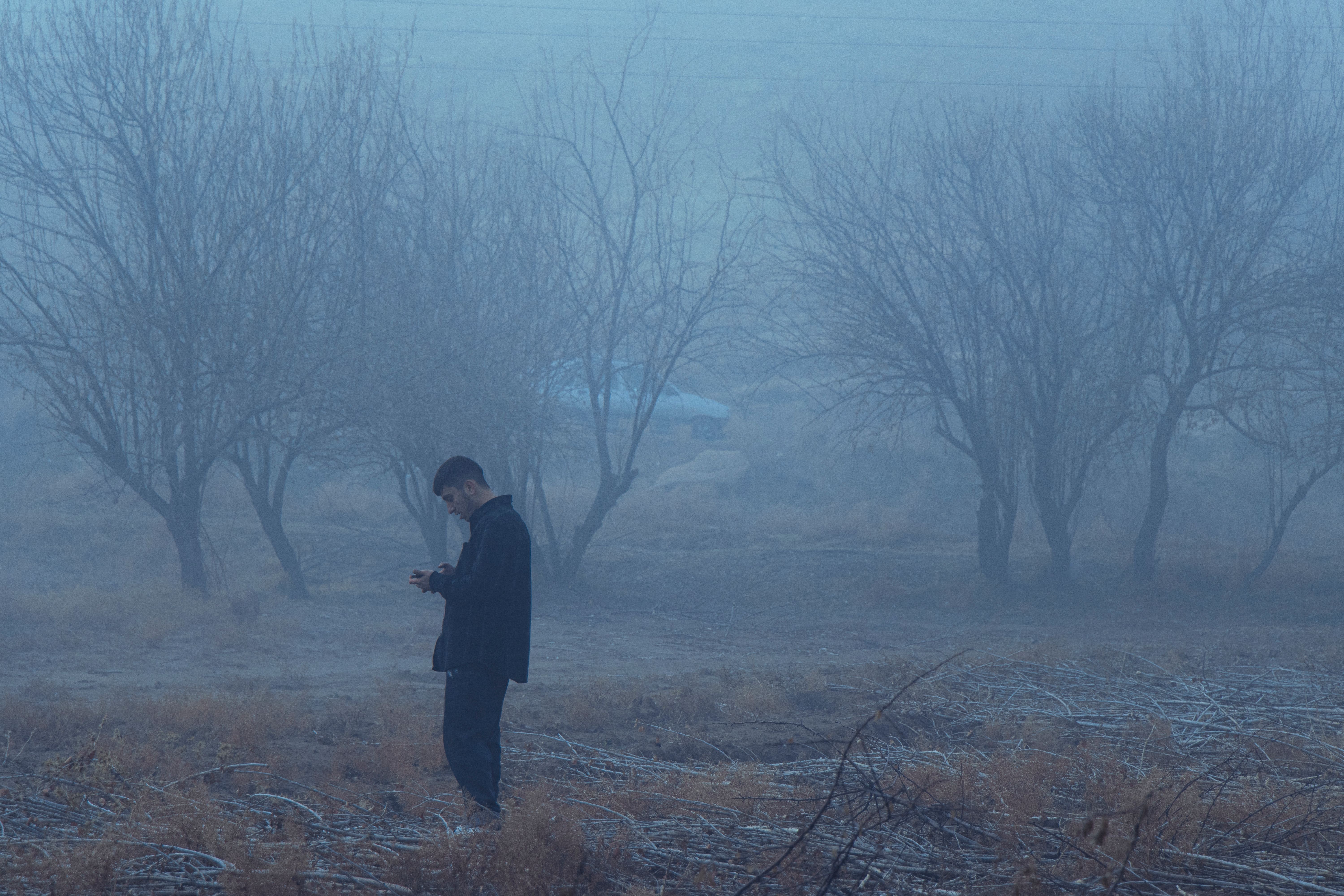 A solitary figure in a foggy landscape in Tabriz, Iran, creating a moody and atmospheric scene.