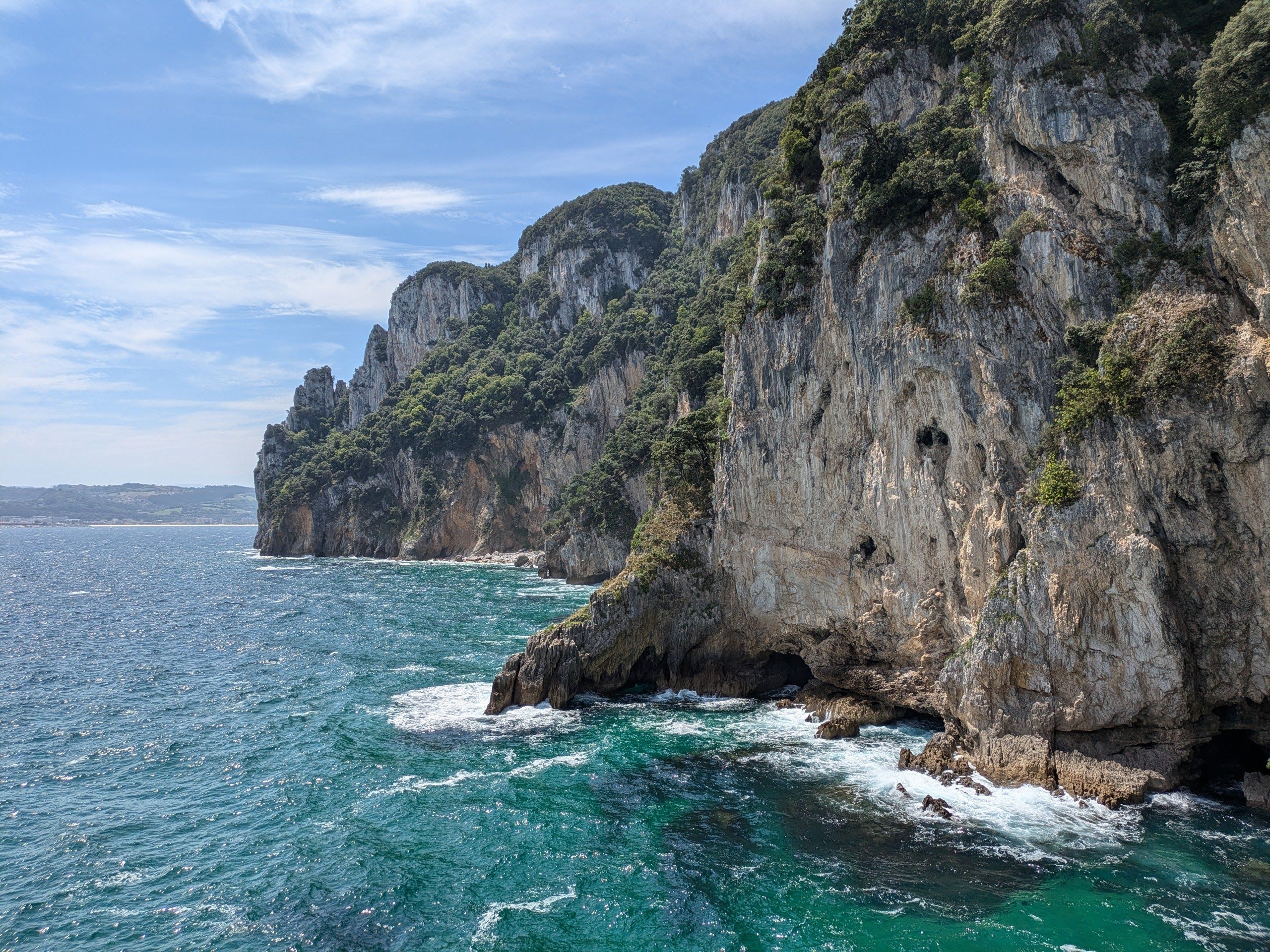 Stunning Coastal Cliffside With Azure Waves Free Stock Photo