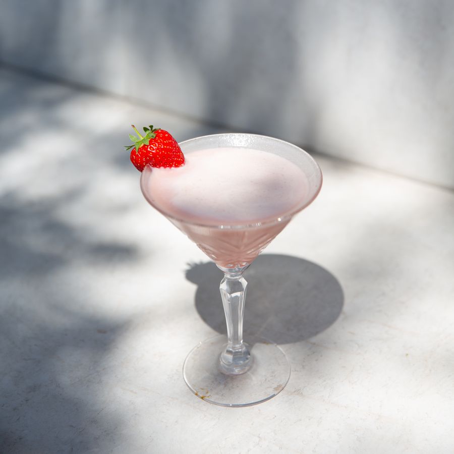 Strawberry cream drink in a coupe glass on a pale stone surface, photo by The Castlebar on Pexels