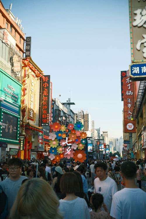 Free Bustling urban street filled with people and colorful signs in an outdoor market setting. Stock Photo