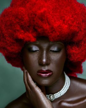 Artistic portrait of a woman with vibrant red hair and pearls, exuding elegance. - Fotografer Sidoarjo