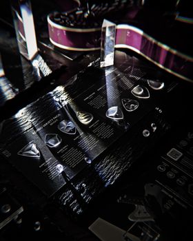 Close-up of guitar picks with an electric guitar and reflective surfaces.