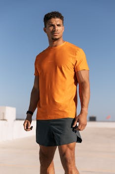 Man in vibrant athleisure outfit posing on a sunny Austin rooftop.