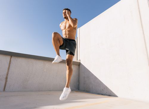Free Male athlete doing cardio workout on a rooftop under blue sky in Austin, Texas. Stock Photo