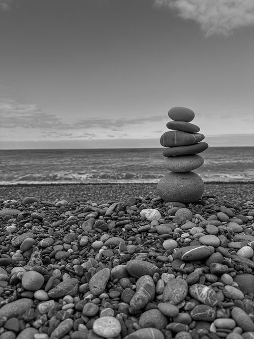 Free Black and white image of stacked stones on Cide Beach, Kastamonu, Türkiye, with a calm sea backdrop. Stock Photo