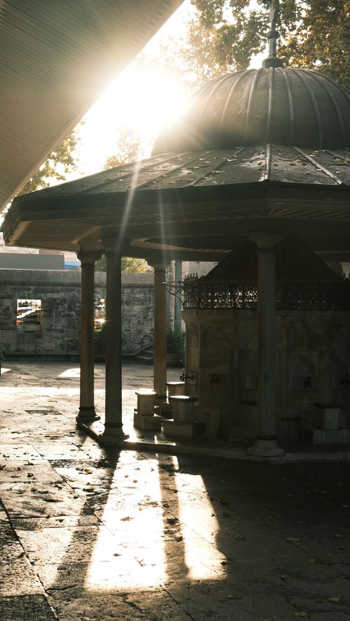 Free Sunlight illuminates an old Ottoman-style fountain in a tranquil historical courtyard. Stock Photo