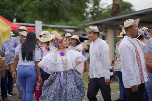 A festive street scene showcasing traditional Panamanian dance and attire during a lively cultural event.