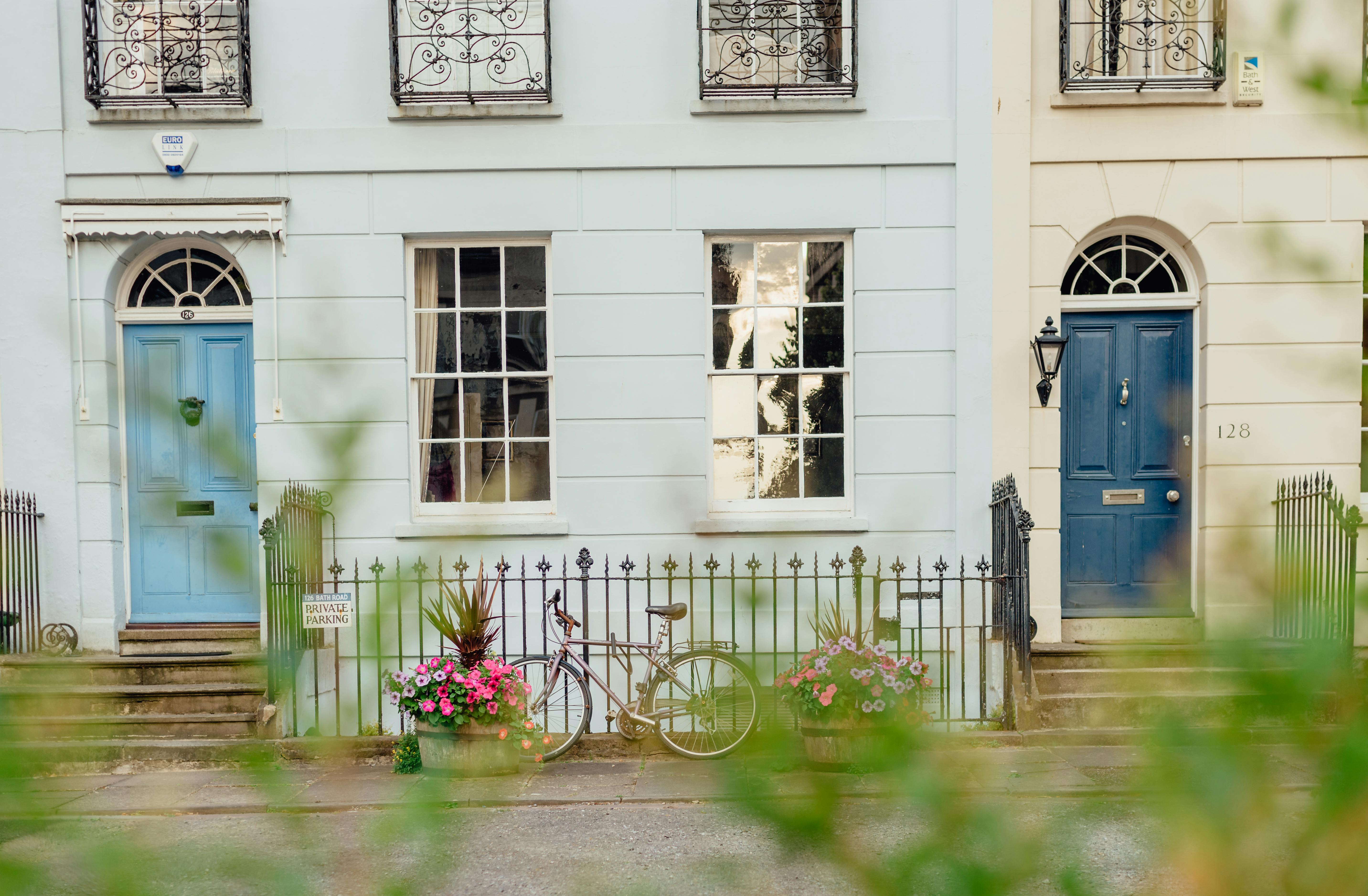 Picturesque street view featuring vintage bicycles and vibrant blue doors, ideal for urban lifestyle imagery.