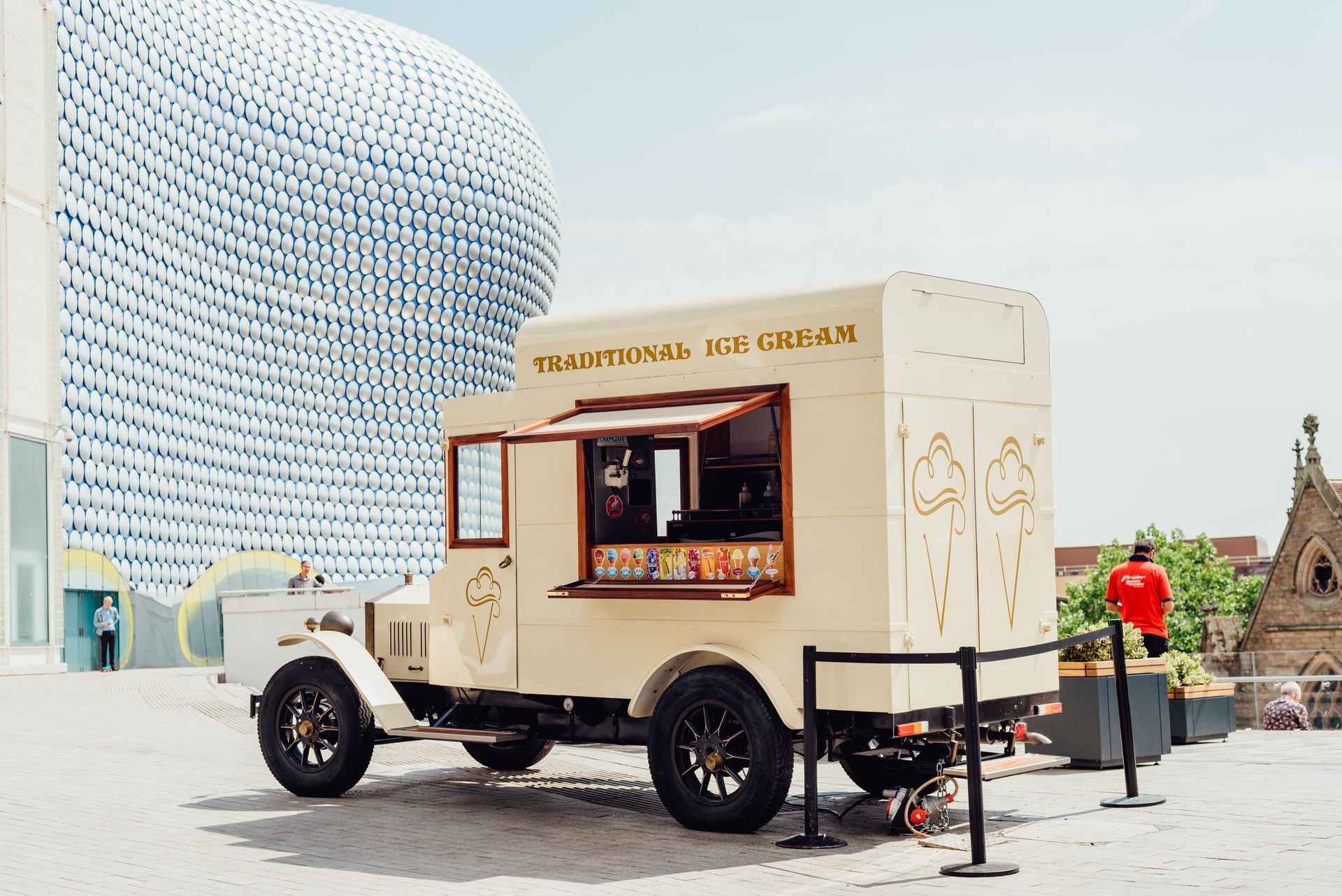 A traditional ice cream truck in a modern city setting, ideal for summer vibes.