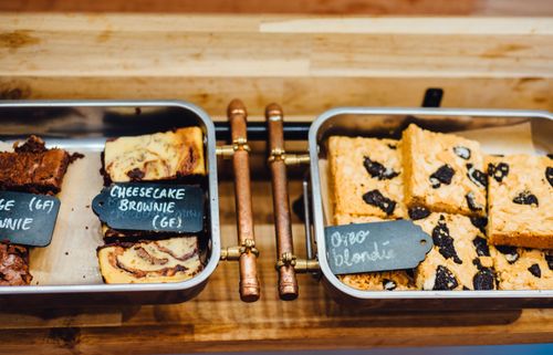 Free A tempting display of gluten-free brownies and blondies in trays, perfect for dessert lovers. Stock Photo