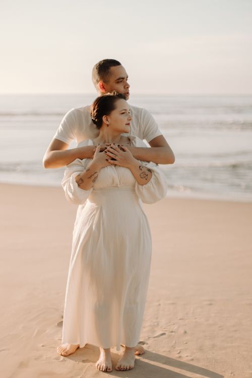 Romantic Couple Embracing on a Beach at Sunset · Free Stock Photo