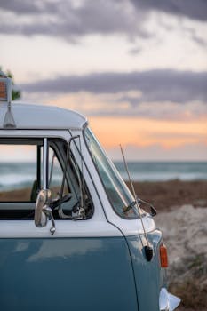 Photo by Janine Speidel Classic VW bus on a serene Hawaii beach at sunset, showcasing a relaxing island vibe.