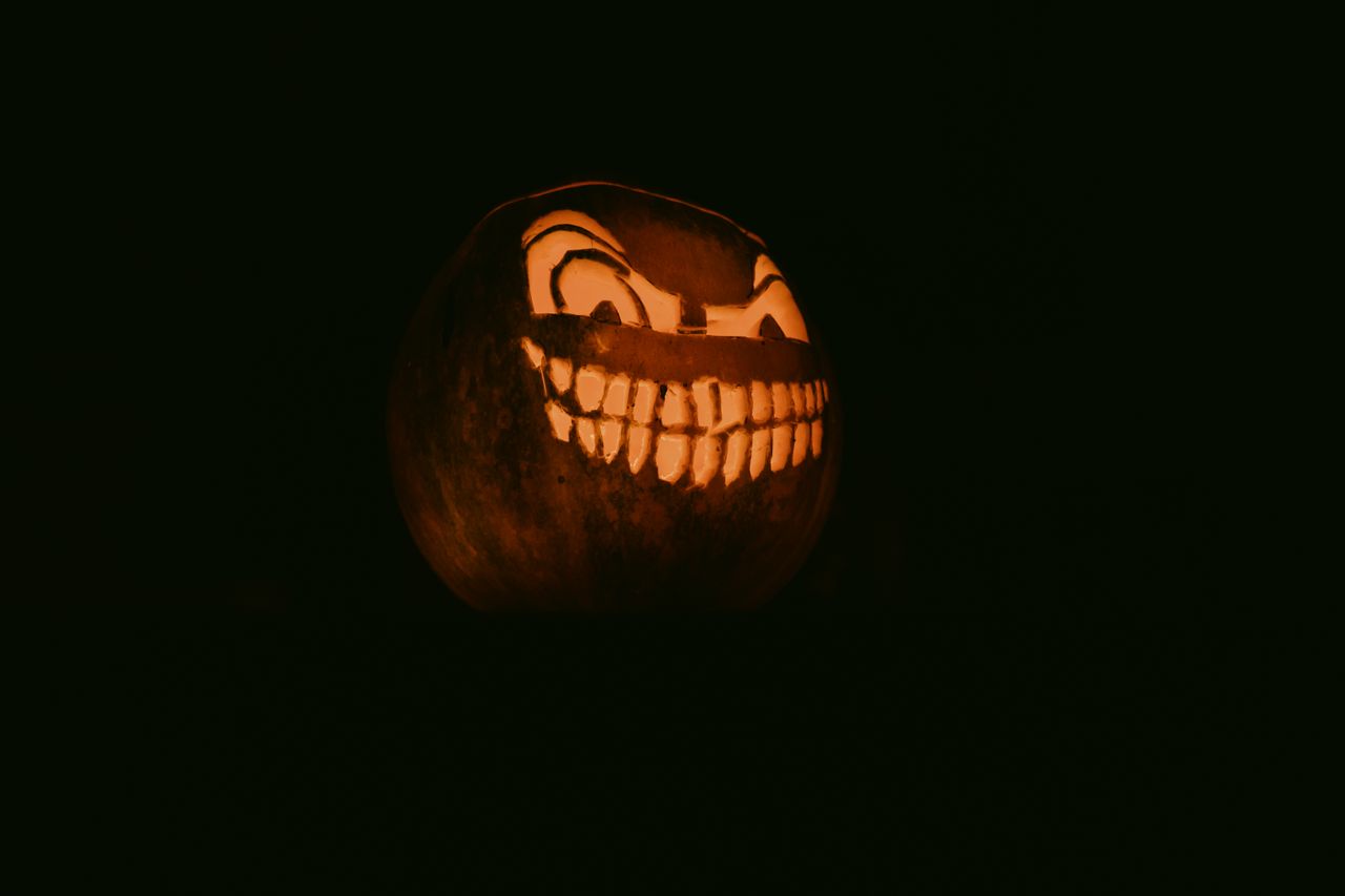 a glowing carved pumpkin with a creepy grin perfect for halloween deco