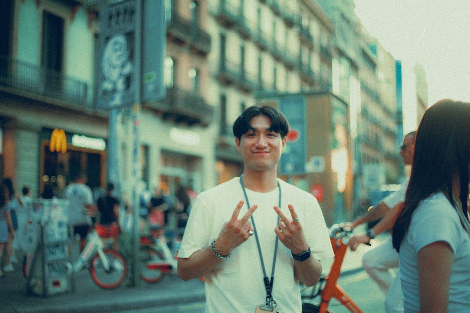 A hand holding a Barcelona T-Casual public transport card, ready for validation.