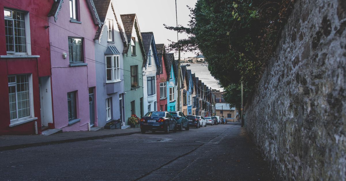 Vibrant row houses line the streets of historic Cobh, Ireland, showcasing colorful architecture.