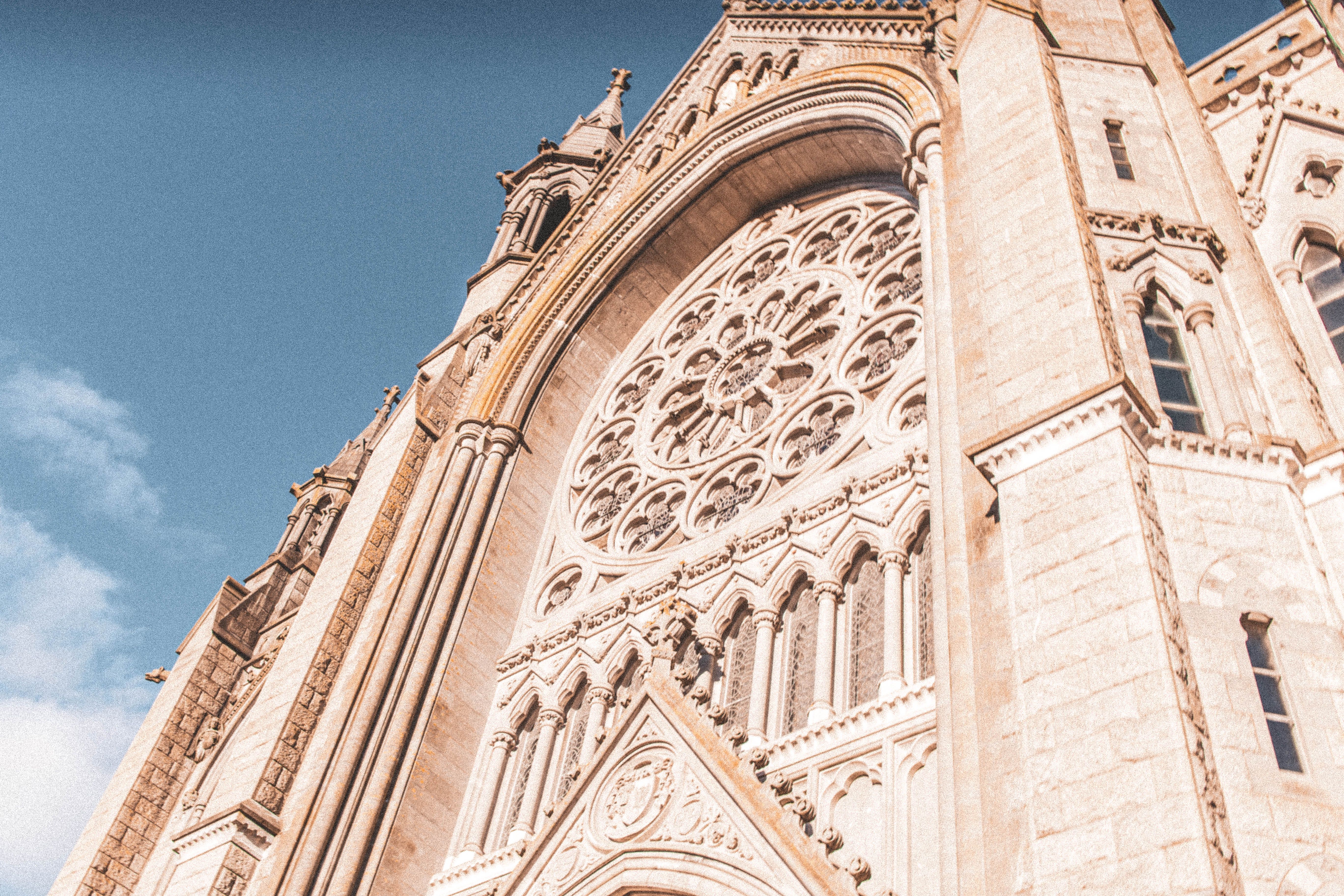 Close-up of St. Colman's Cathedral showcasing intricate gothic stonework in Cobh, Ireland. - Cork