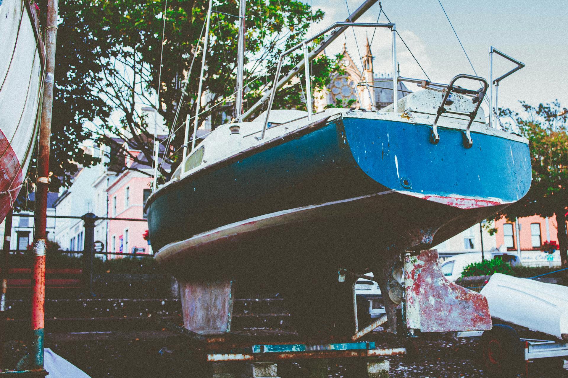 A rustic fishing boat on dry dock in Cobh, County Cork, Ireland. Nautical vibes in a scenic coastal town.