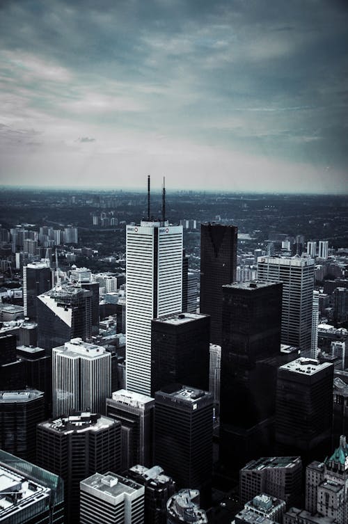 Free Black and White Tall Buildings Under Cloudy Sky Stock Photo