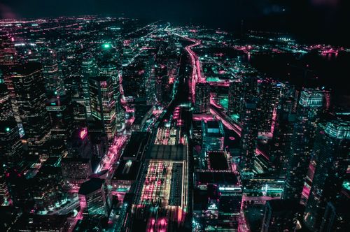 Free A stunning aerial view of Toronto's illuminated cityscape at night, showcasing vibrant lights and skyscrapers. Stock Photo