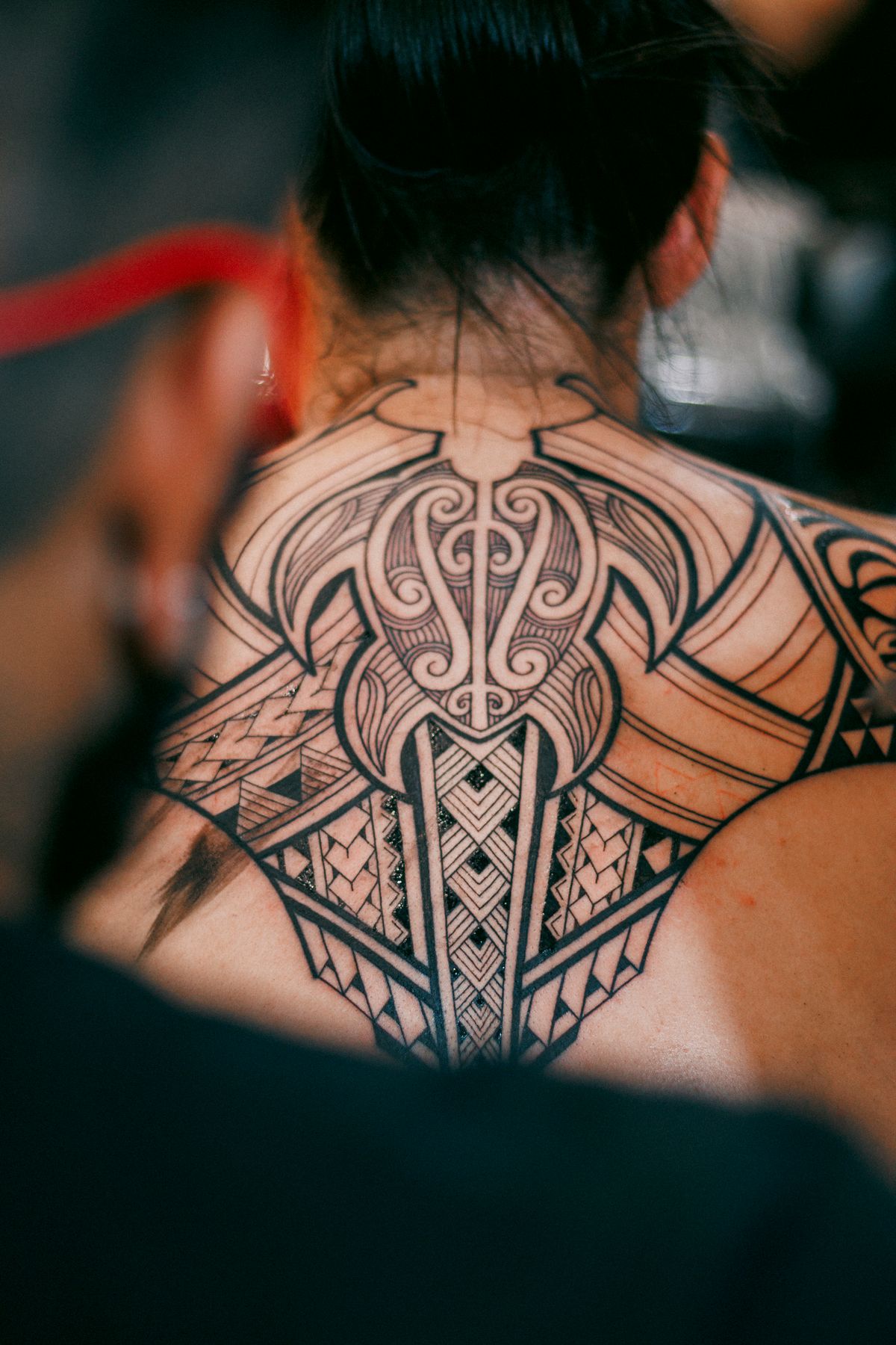 Large blackwork eagle tattoo across a back