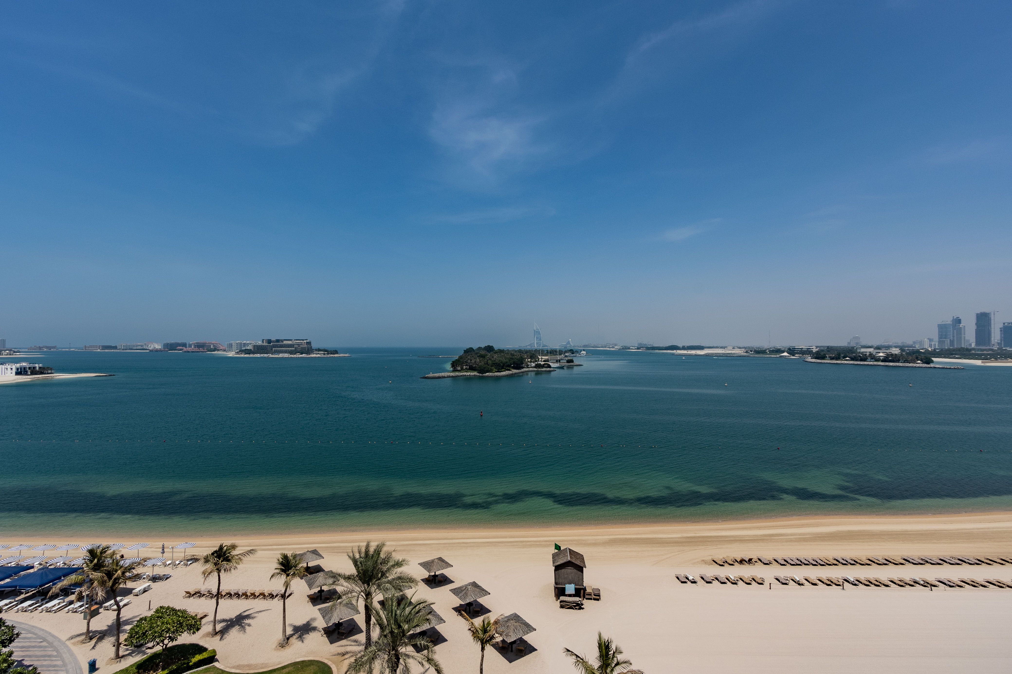 Tourists enjoying a pleasant winter day on a beach in Dubai, UAE