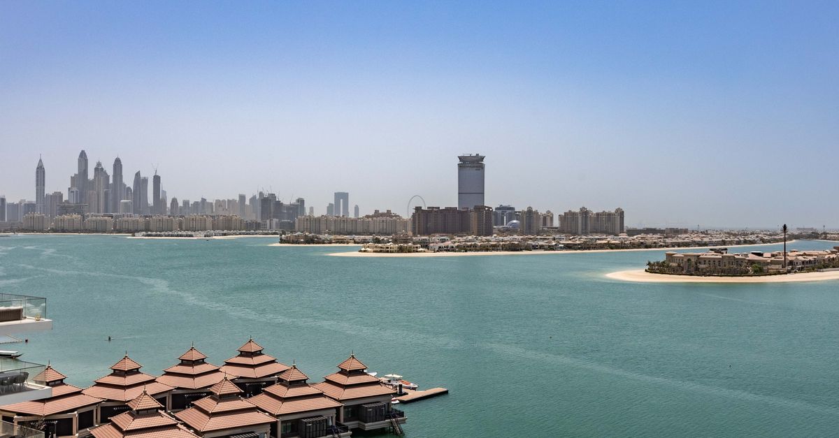Modern high-rise apartment buildings and residential towers stand densely packed under a clear sky in downtown Dubai.
