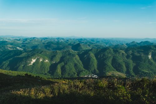 Free Expansive view of lush green mountain ranges under a clear blue sky, showcasing nature's beauty. Stock Photo
