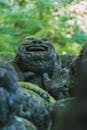 Ancient Stone Statue Amidst Lush Greenery