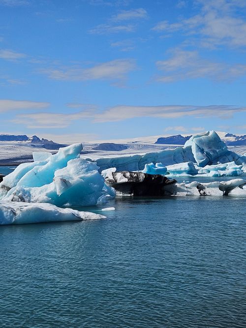 Free Stunning icebergs floating in the Jökulsárlón glacier lagoon under a bright blue sky in Iceland. Stock Photo