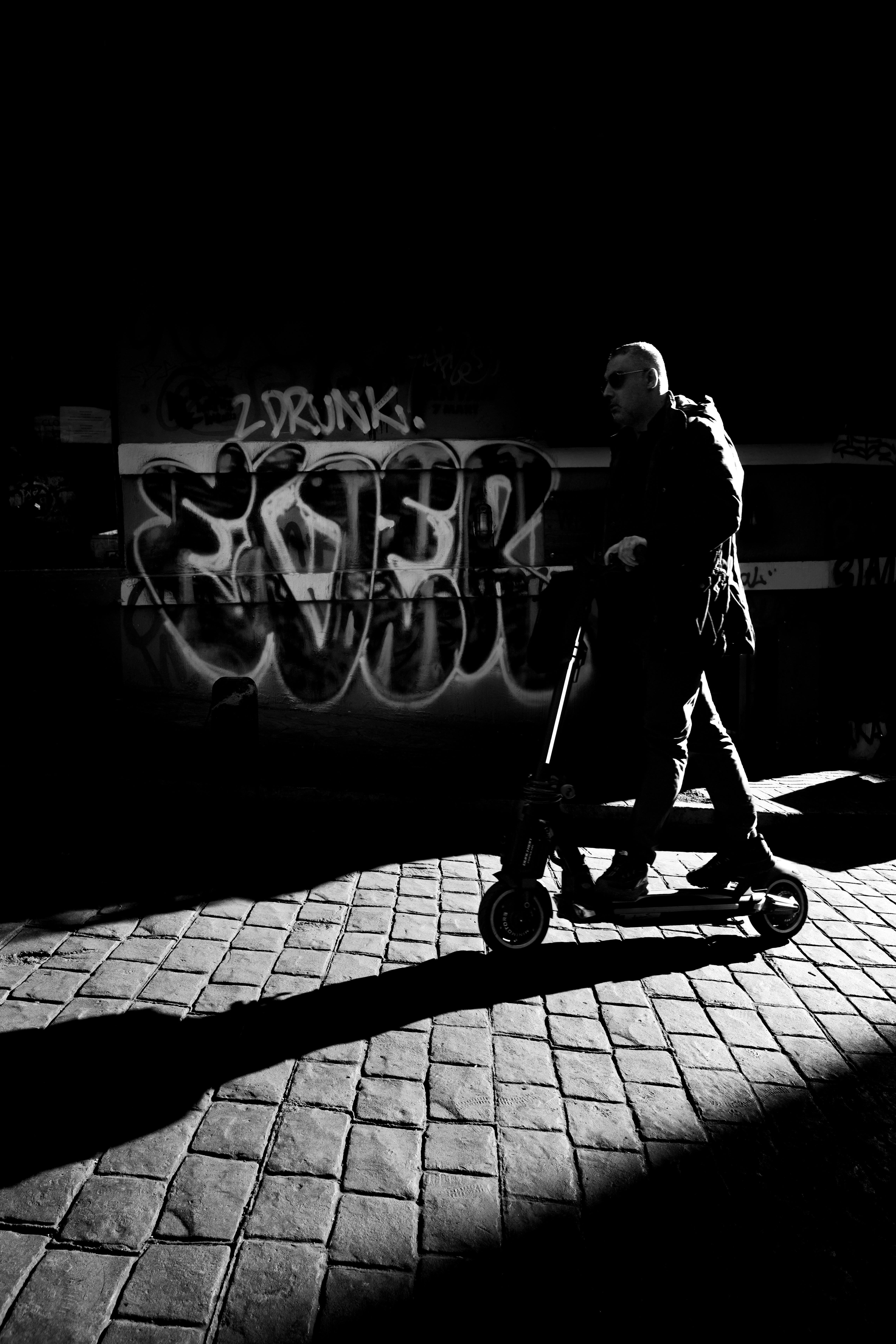 Striking black and white street photo of a person on a scooter in Istanbul, Turkey.