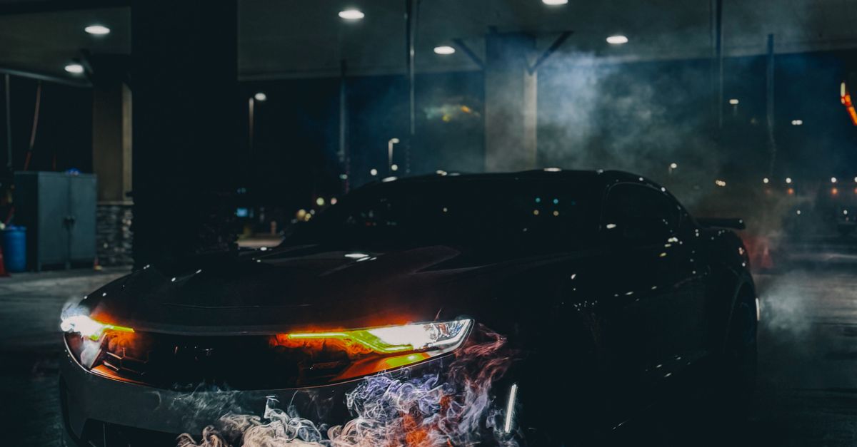 Sleek Sports Car Emitting Smoke At Night Free Stock Photo sleek-sports-car-emitting-smoke-at-night-free-stock-photo