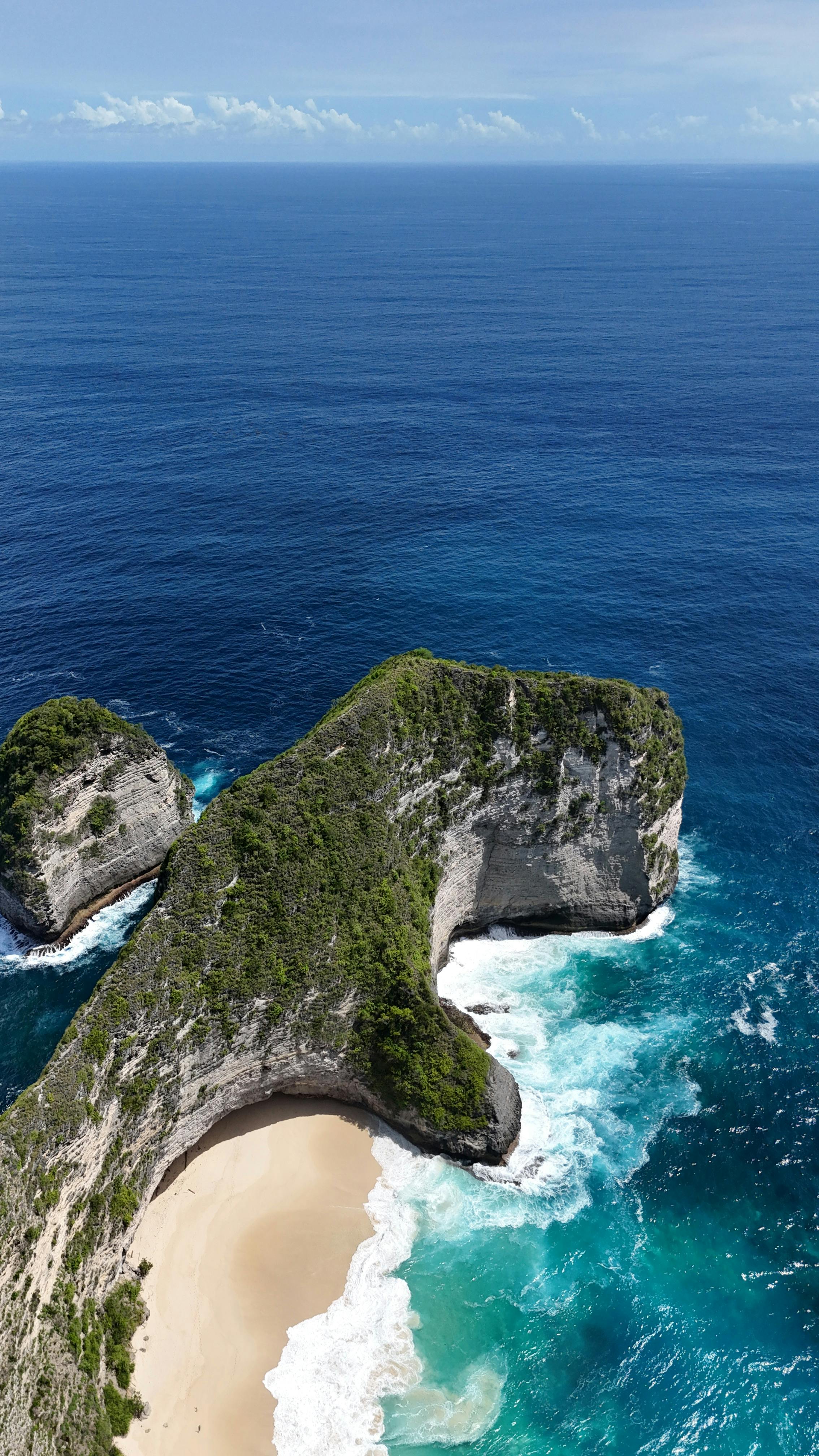 Aerial view of Kelingking Beach and its iconic T-Rex shaped cliff on Nusa Penida island near Bali