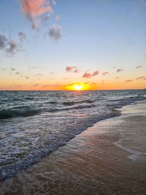 Free Serene ocean waves and colorful sunrise on a Dominican beach. Stock Photo