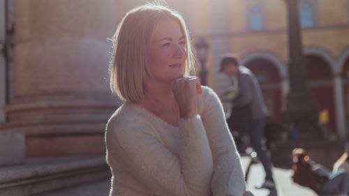 Free A middle-aged woman enjoying a sunny day outdoors in Munich, Germany. Stock Photo