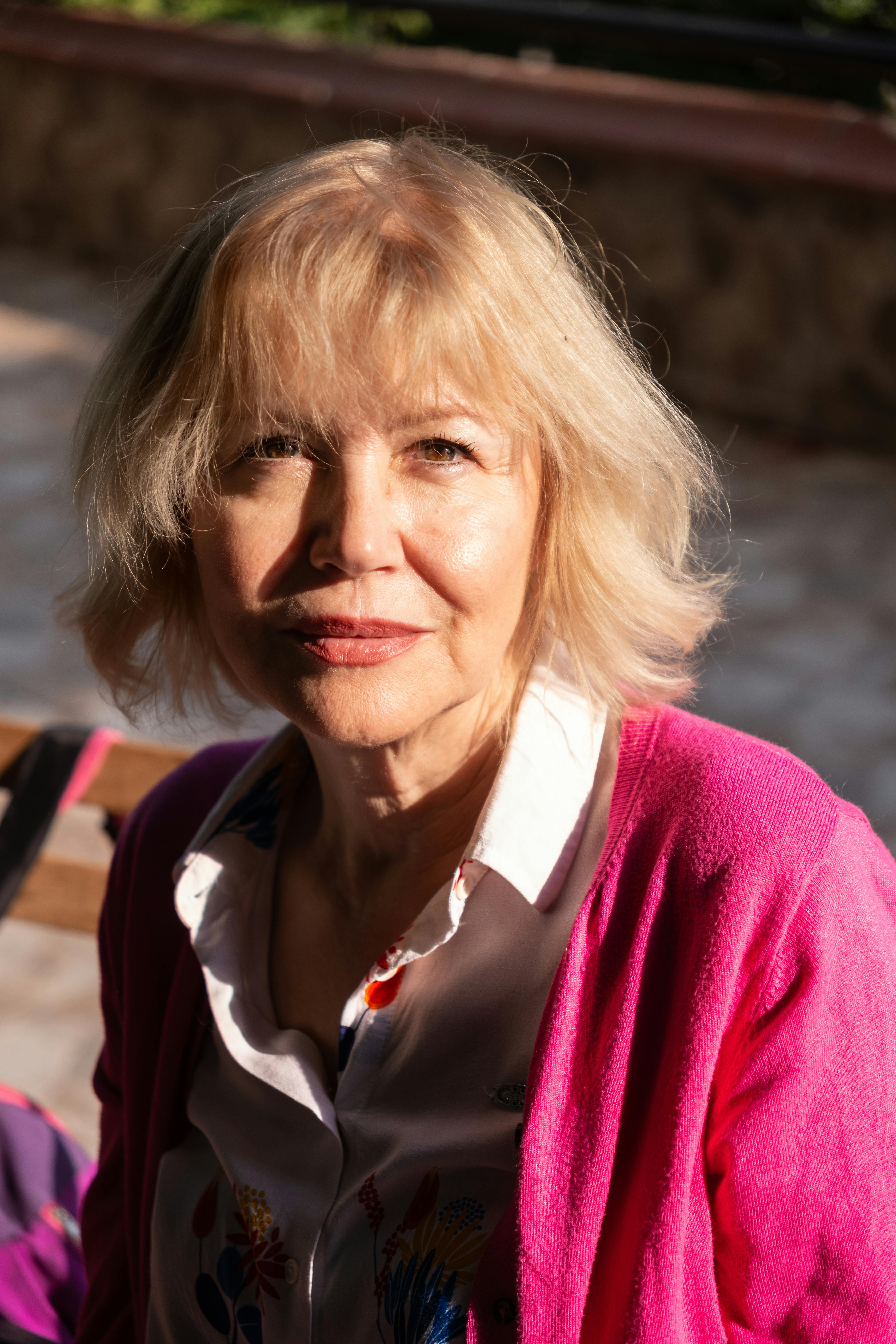 Elegant portrait of a senior woman enjoying a sunny day in Izmir, Turkey.
