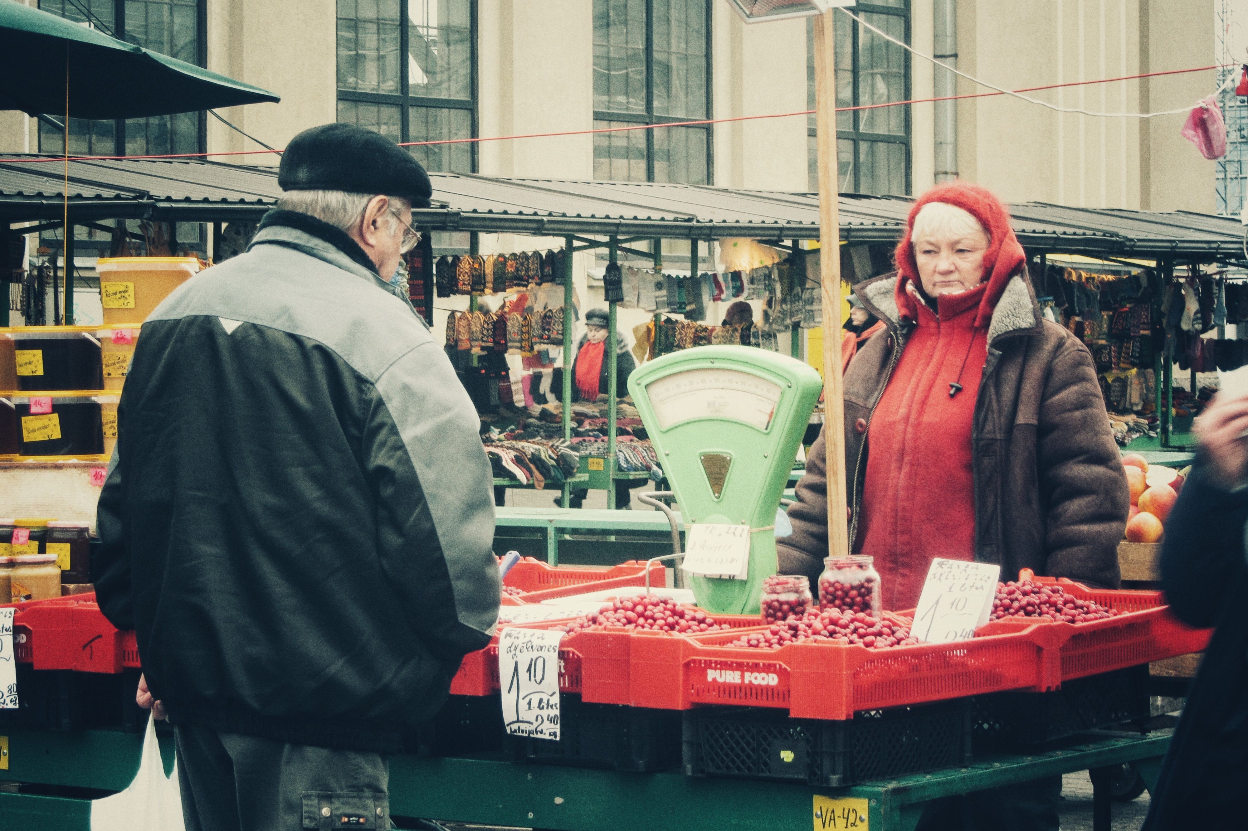 Outdoor Market Scene with Fruit Vendor and Customer · Free Stock Photo