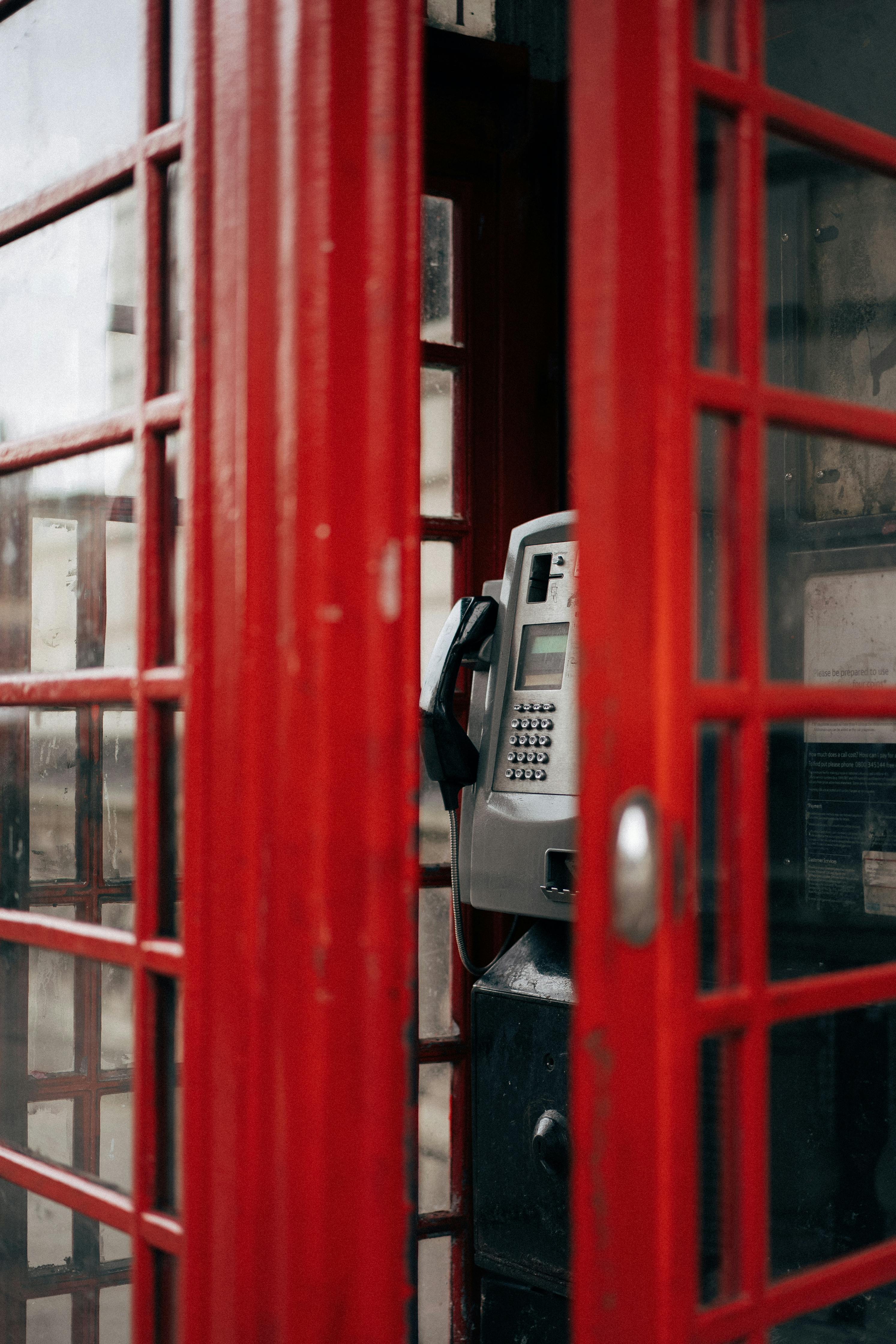 Close-up of an iconic red telephone booth in London showcasing vintage design.