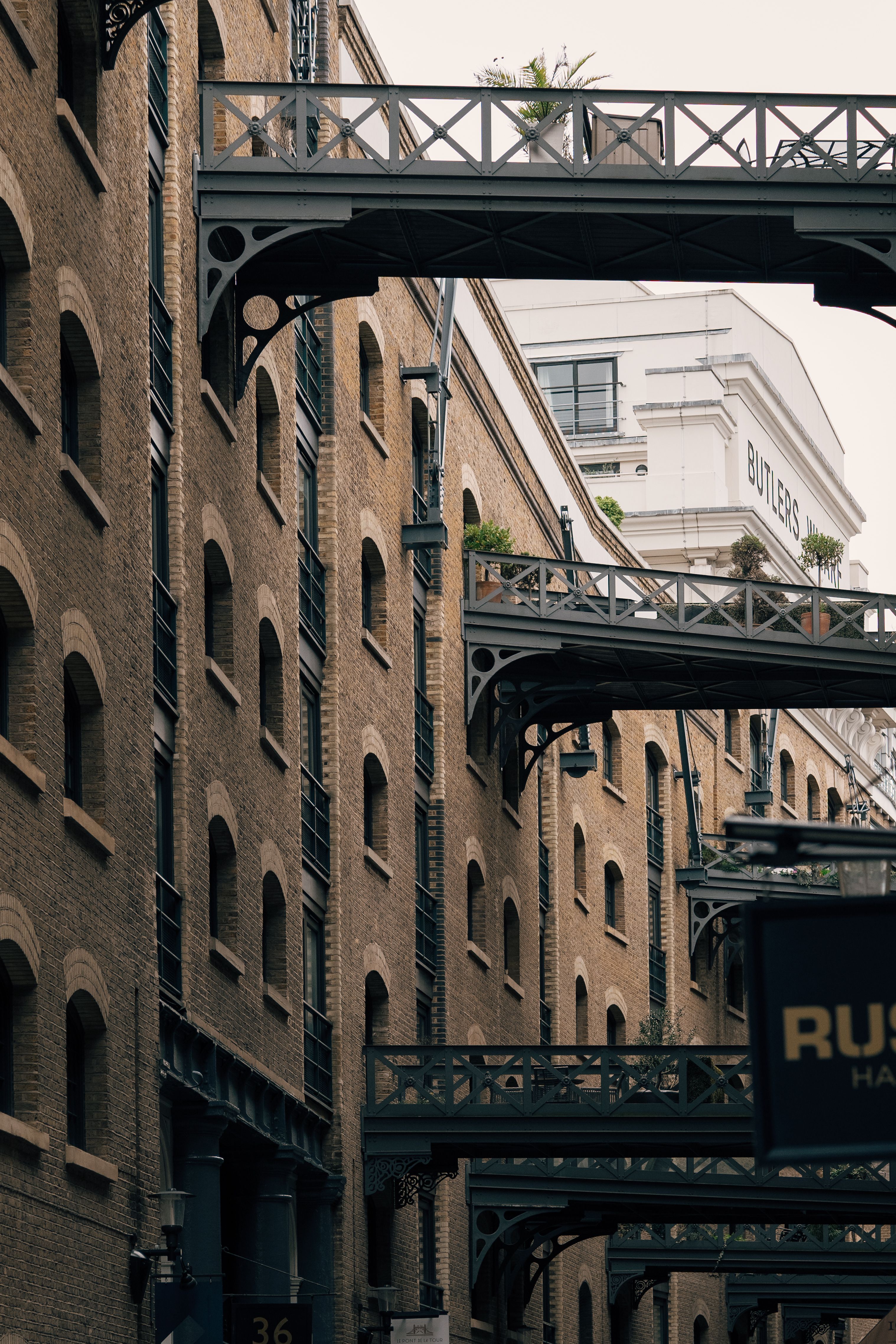 Old brick buildings and iron bridges in London's iconic architecture.