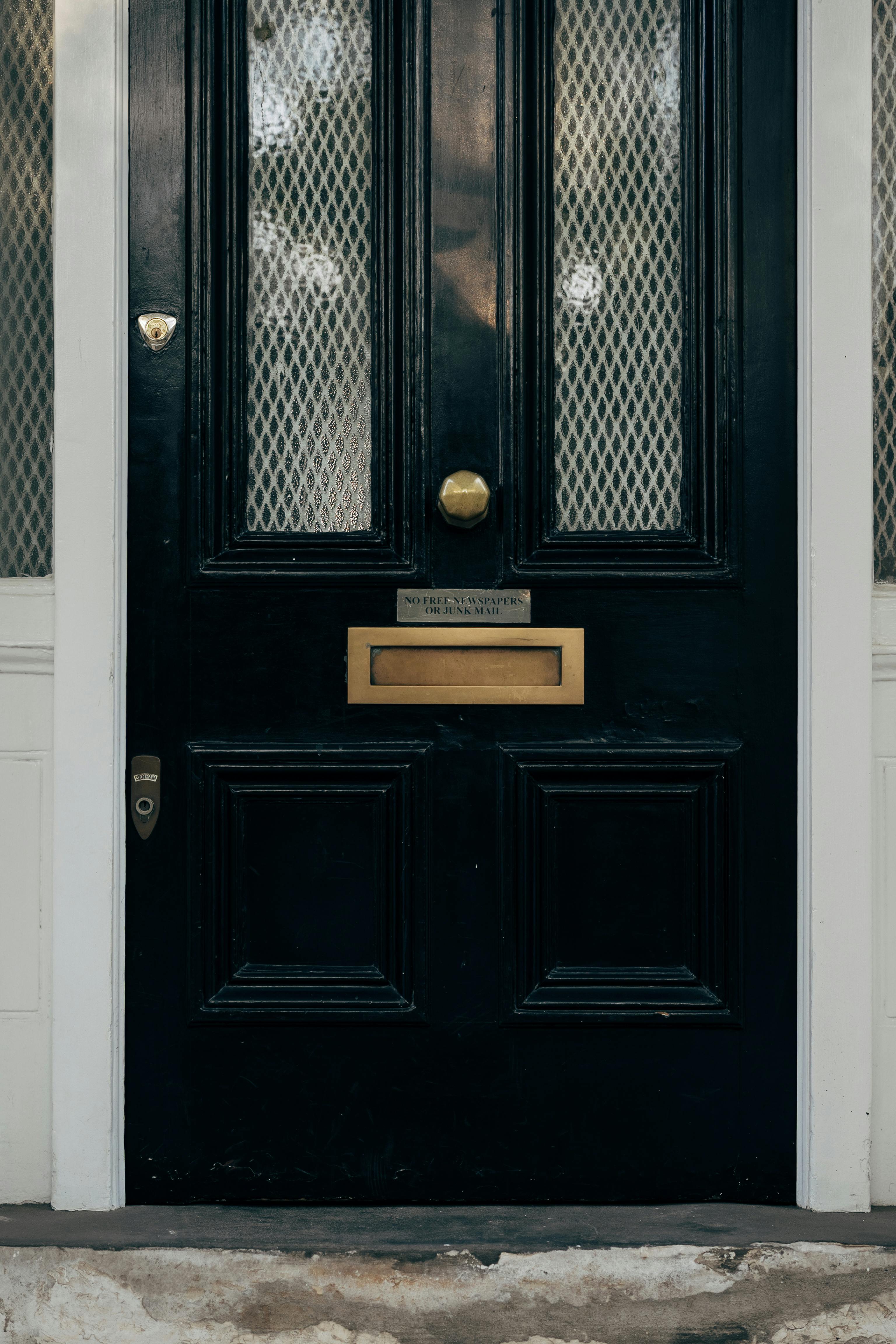 classic black door with brass fixtures in london