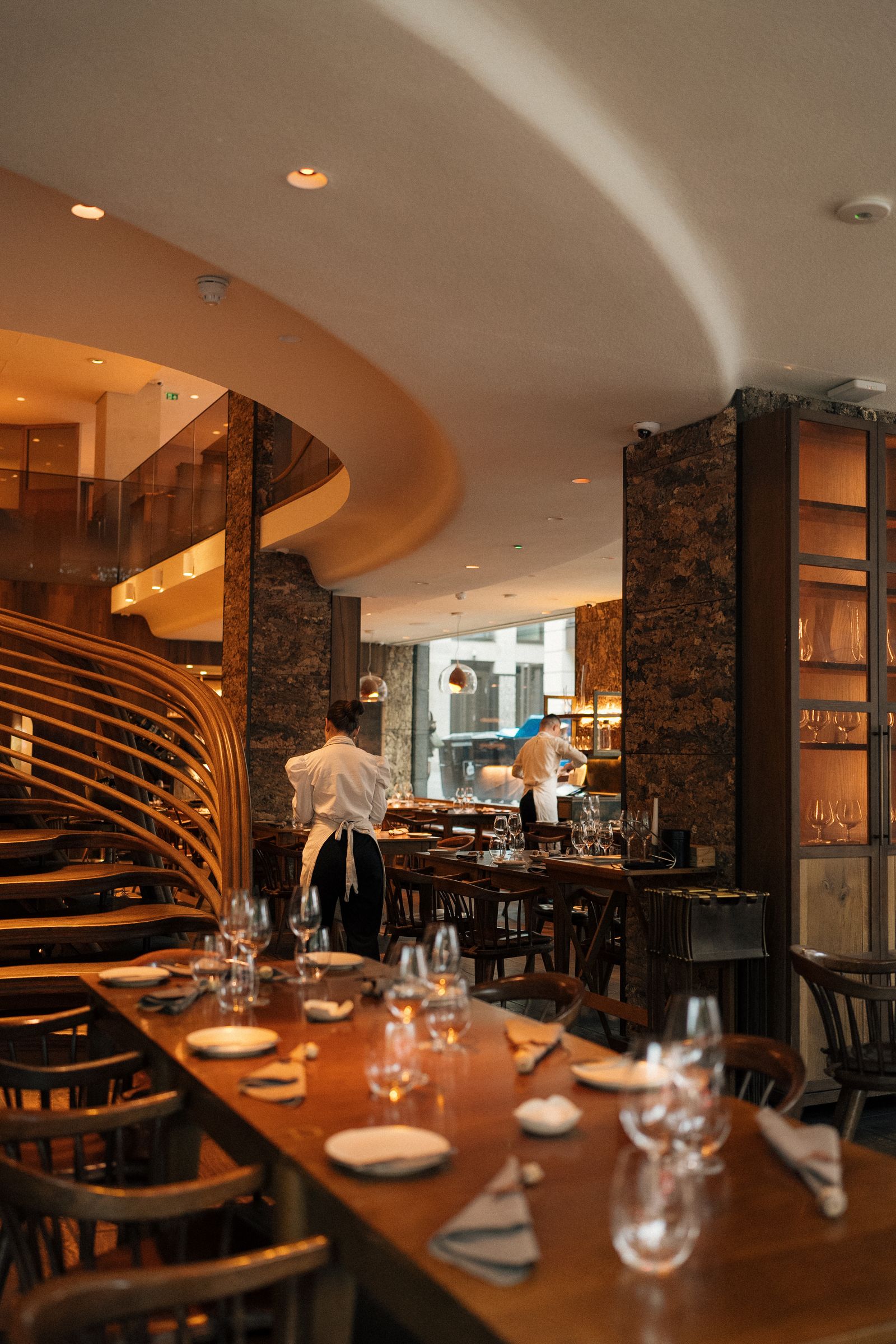 Staff preparing an elegant modern restaurant for service