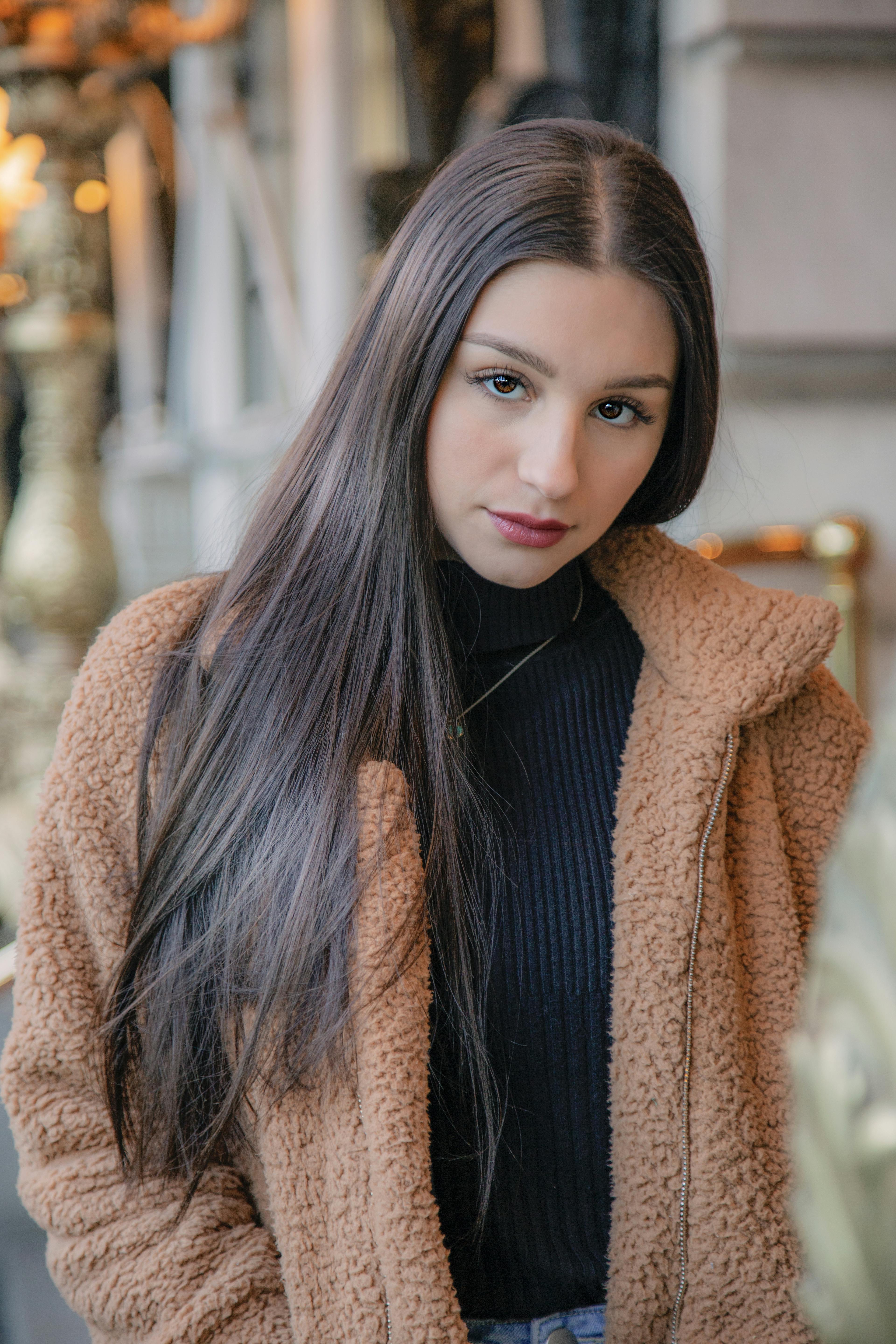 woman wearing brown jacket