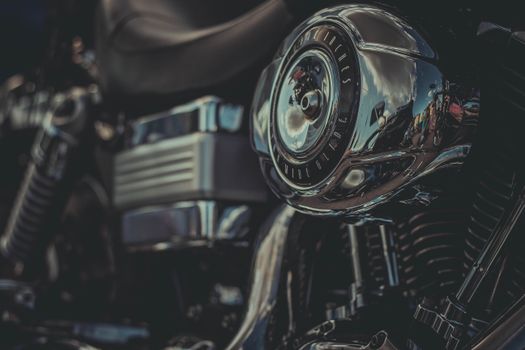 Detailed view of a chrome motorcycle engine part with reflections.