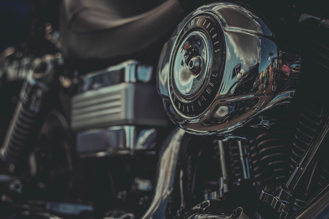 detailed view of a chrome motorcycle engine part with reflections